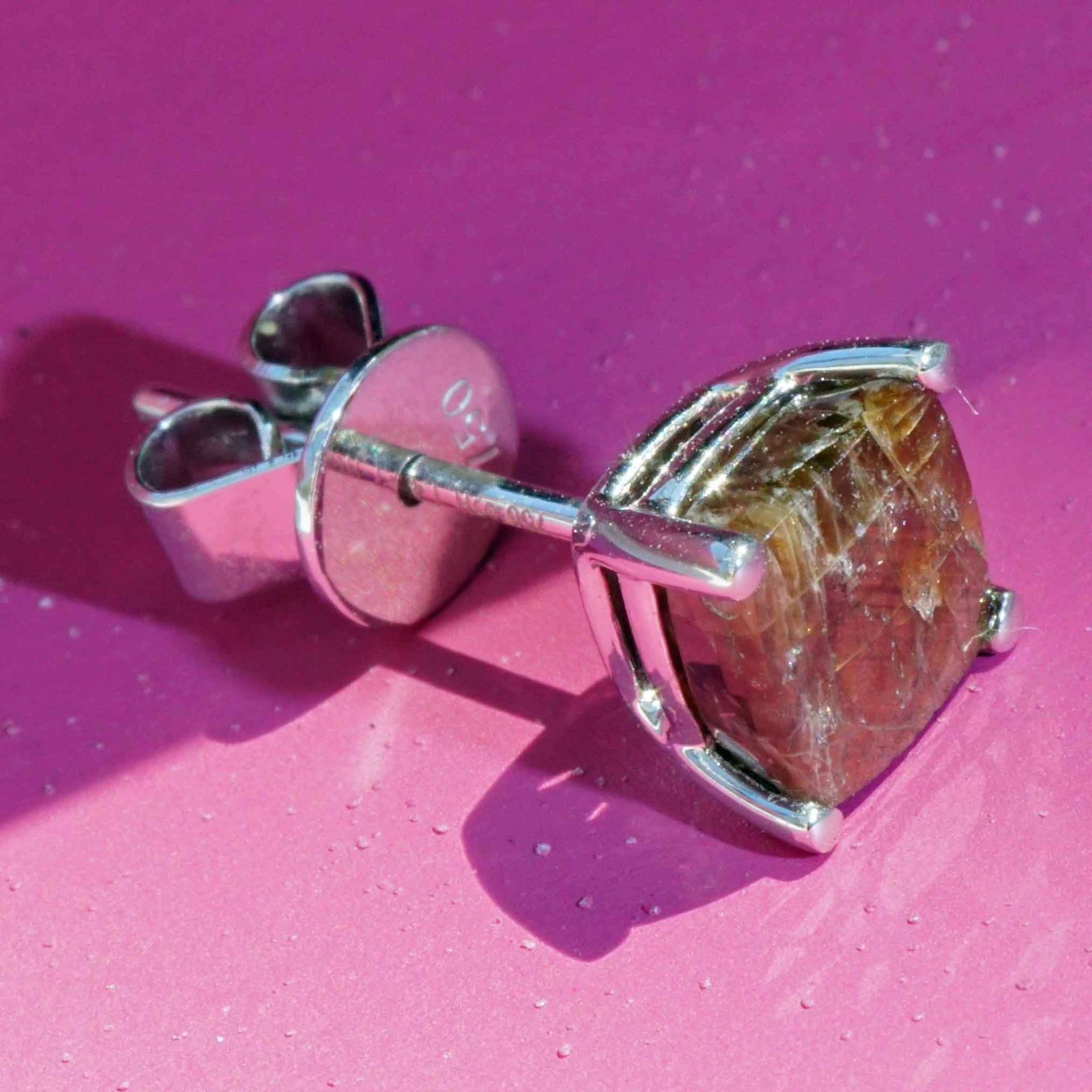 Single ear stud with a rare gold colored sapphire