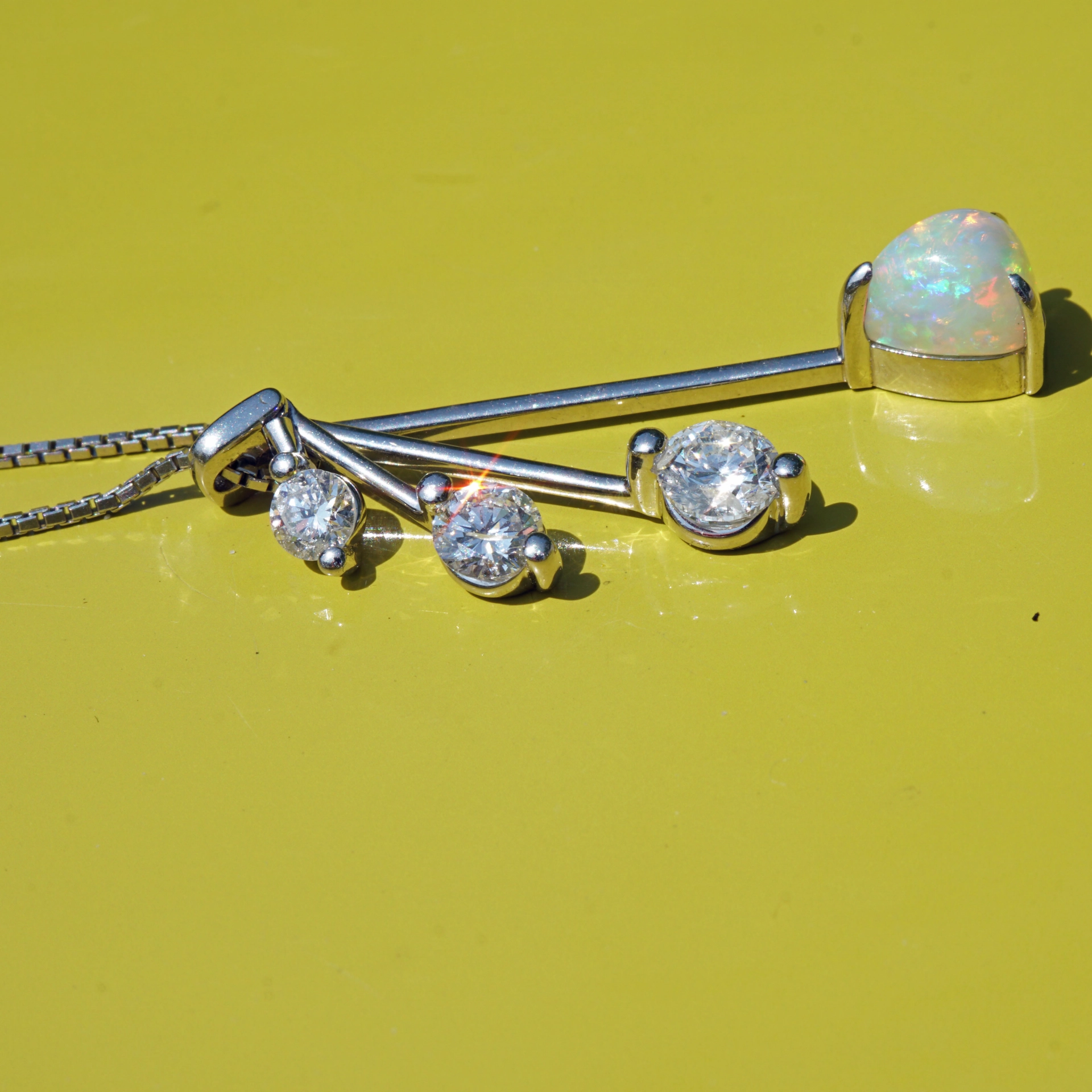 like a mobile....very pretty opal pendant with diamonds platinium setting