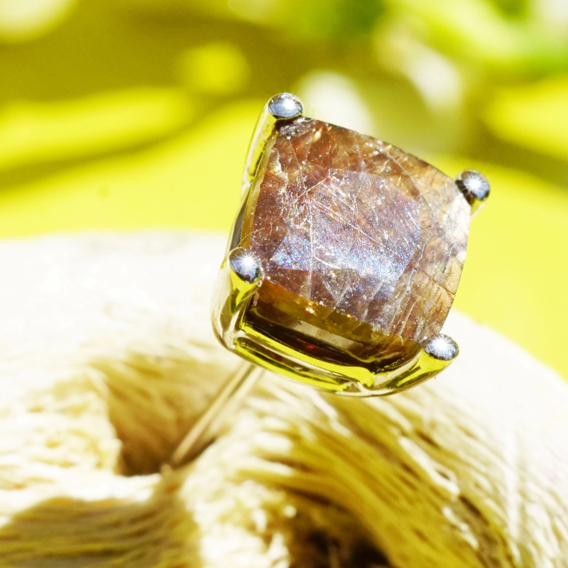 Single ear stud with a rare gold colored sapphire