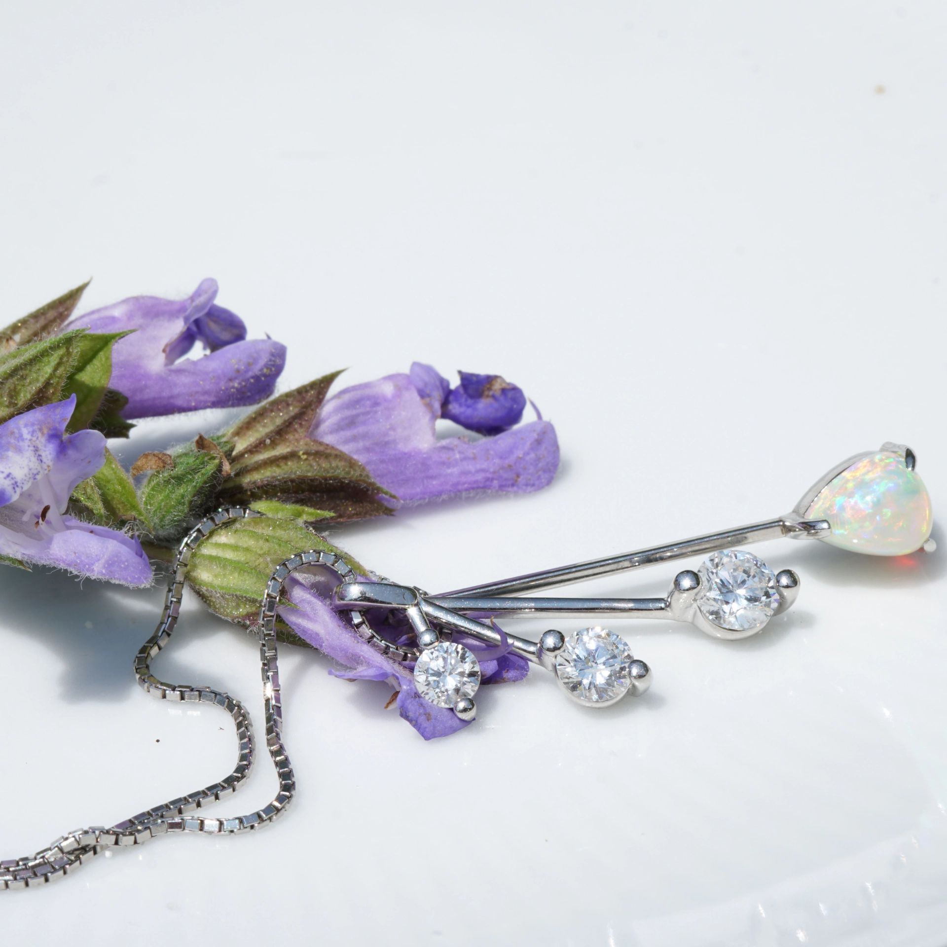 like a mobile....very pretty opal pendant with diamonds platinium setting