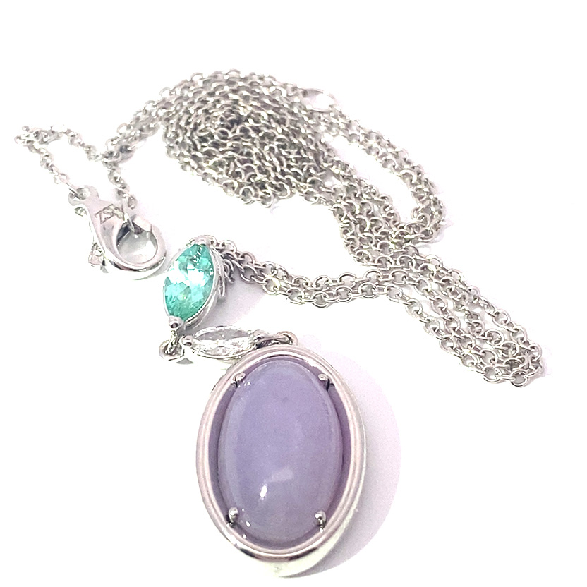 great paraiba turmalin of 1.18 ct, AAA brilliant. swimmingpool blue-green color, original from brasil, 18 kt whitegold, combinated with a princess cut diamond 0.36 ct