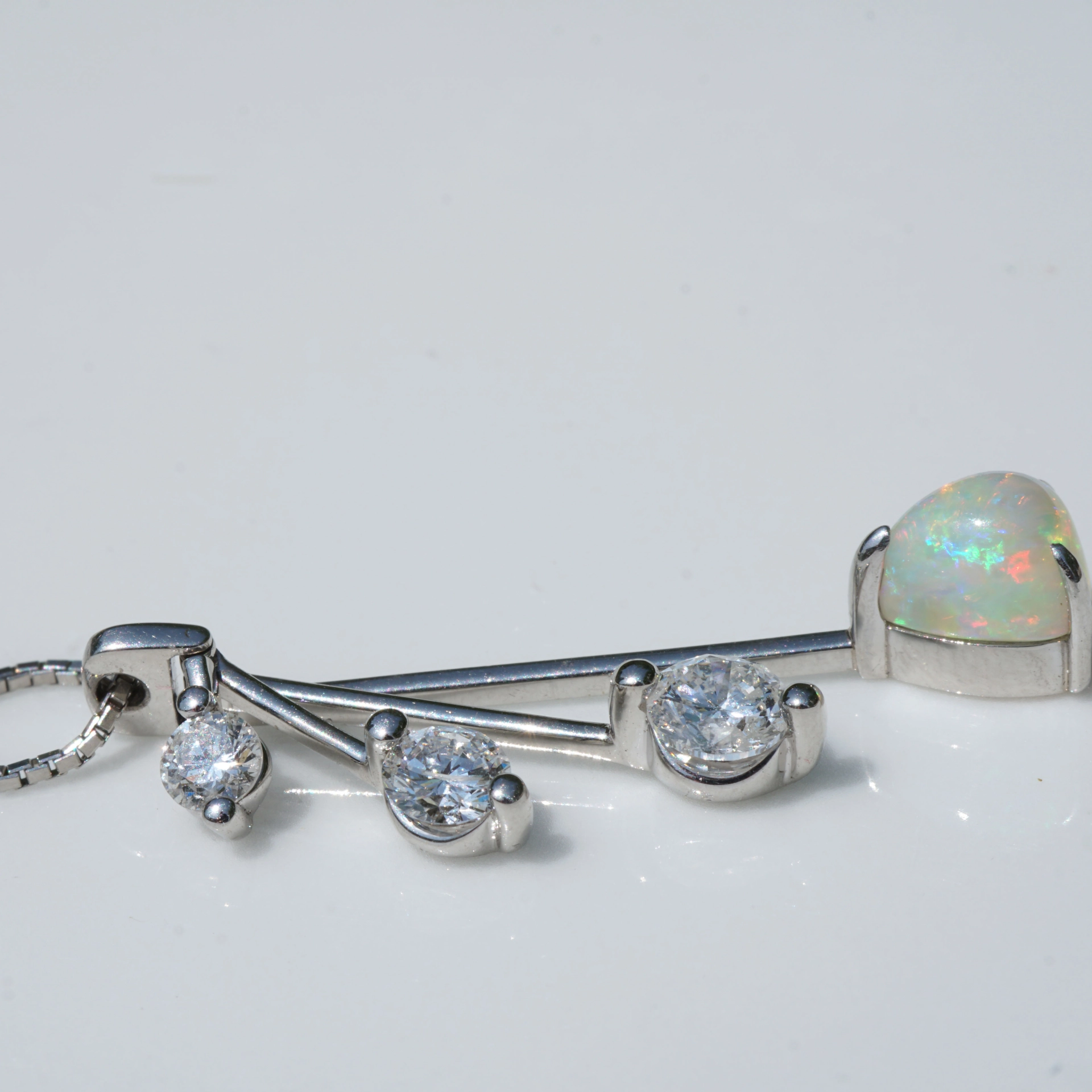 like a mobile....very pretty opal pendant with diamonds platinium setting