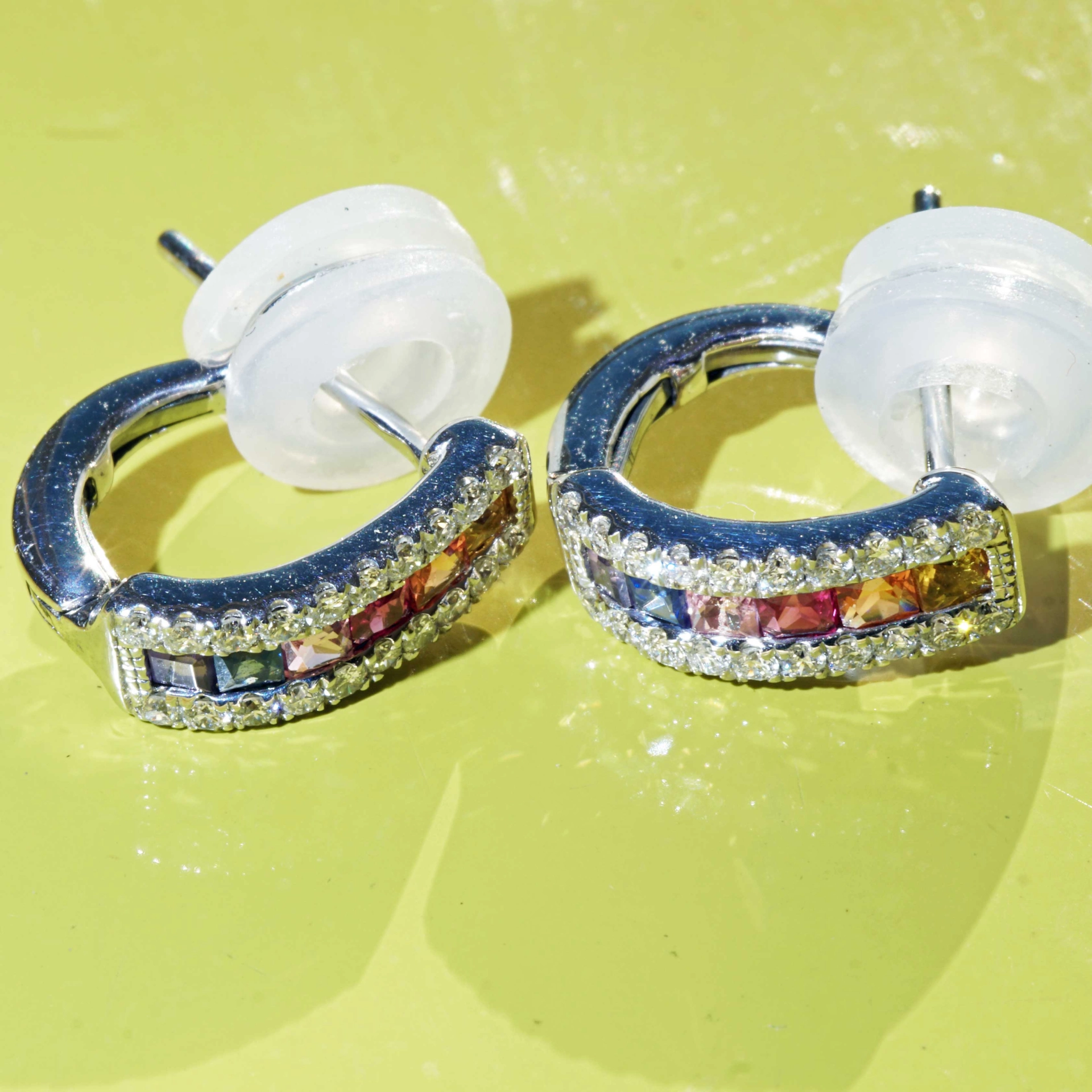 Half Creoles with Bar of colored Saphires, Rubies, Amethyst and Brilliants 18 kt White Gold