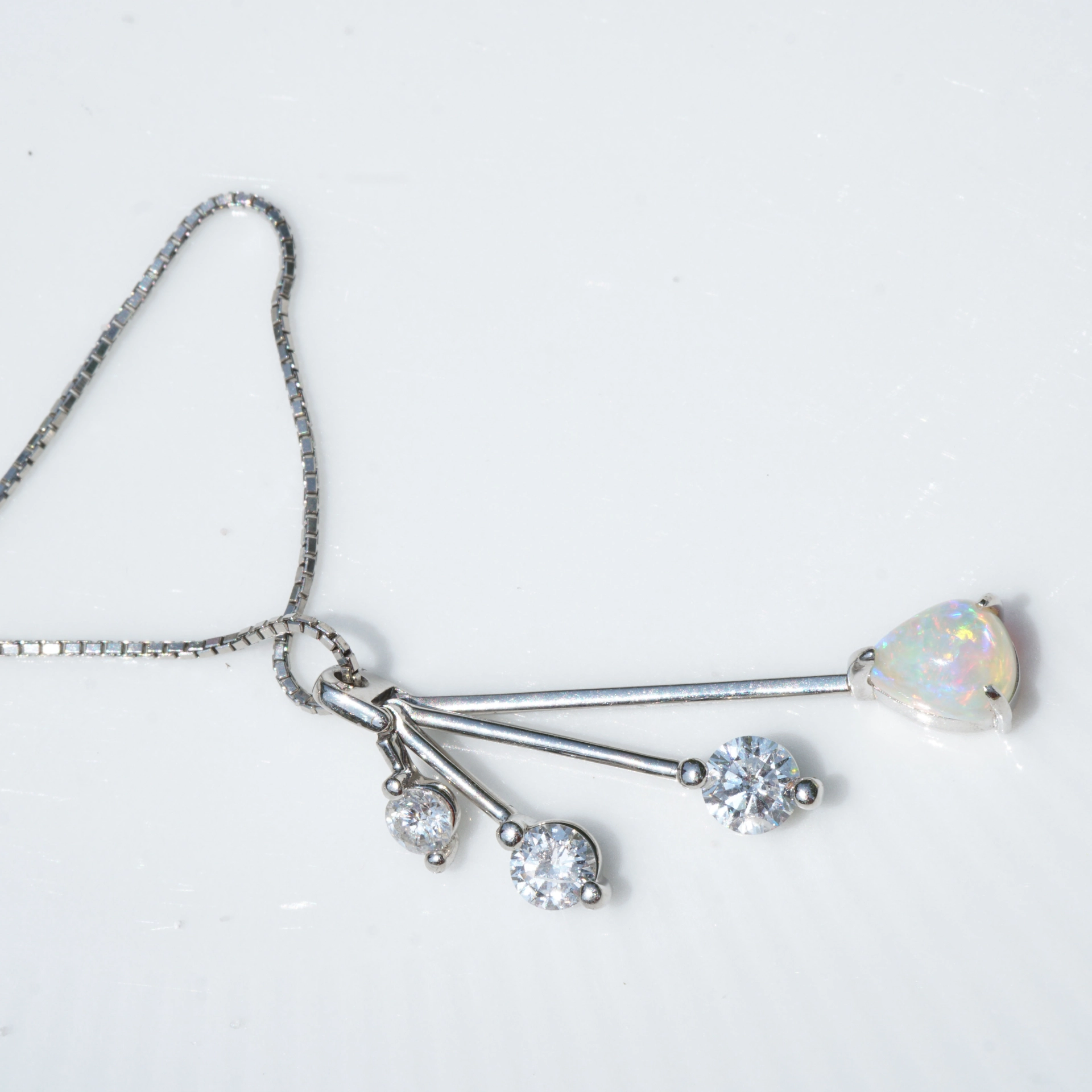 like a mobile....very pretty opal pendant with diamonds platinium setting