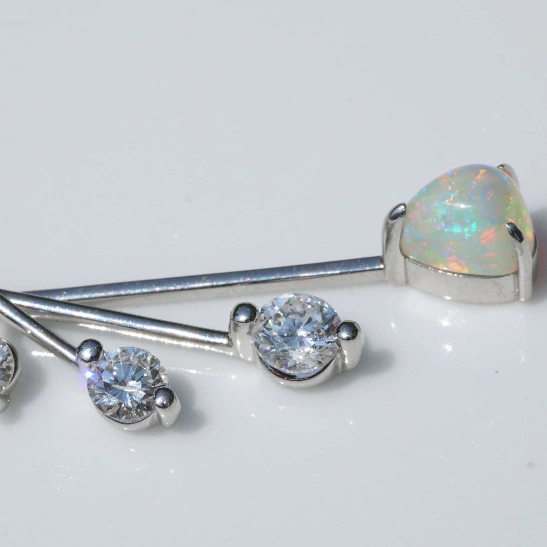 like a mobile....very pretty opal pendant with diamonds platinium setting