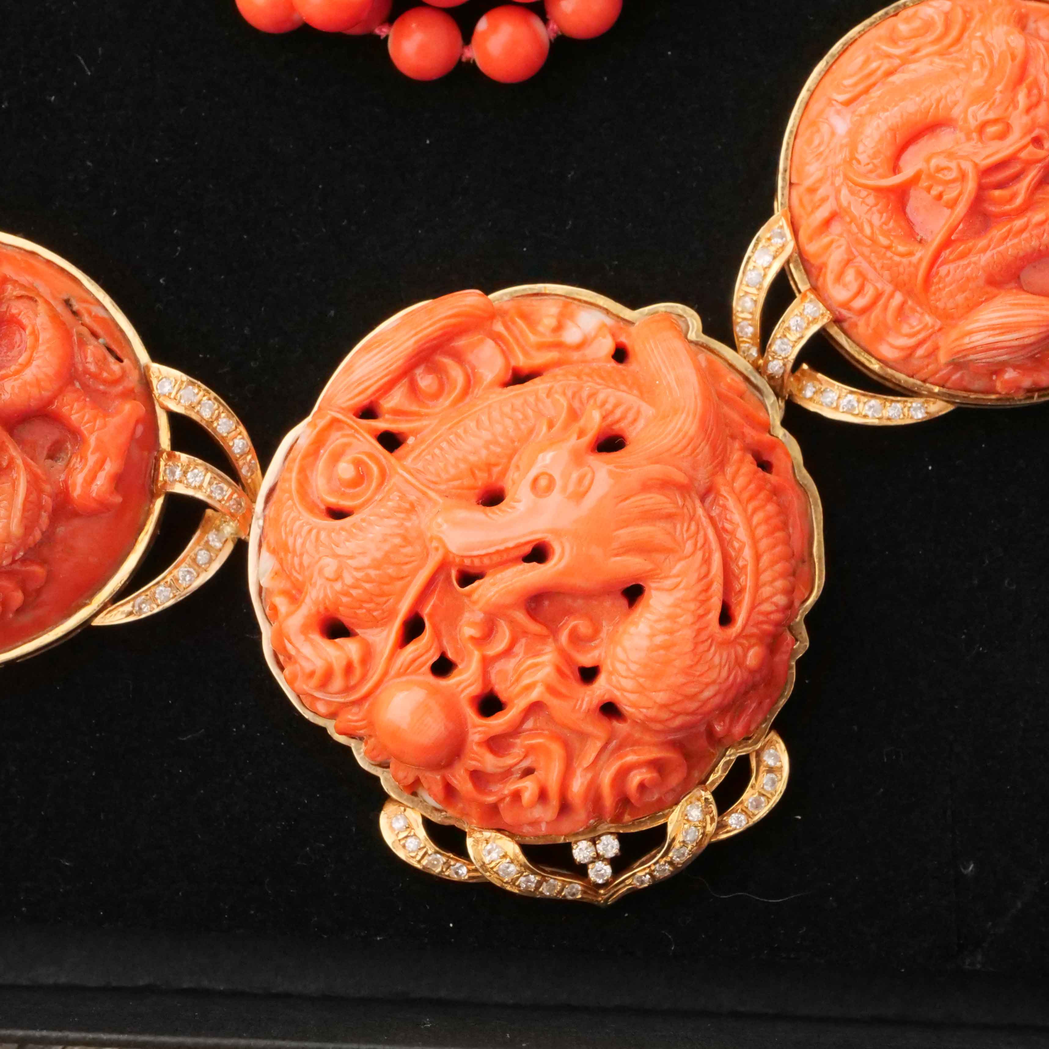 Coral Brilliant Necklace around 1980 with carved Dragon Motifs and four-row Coral Ball Chain