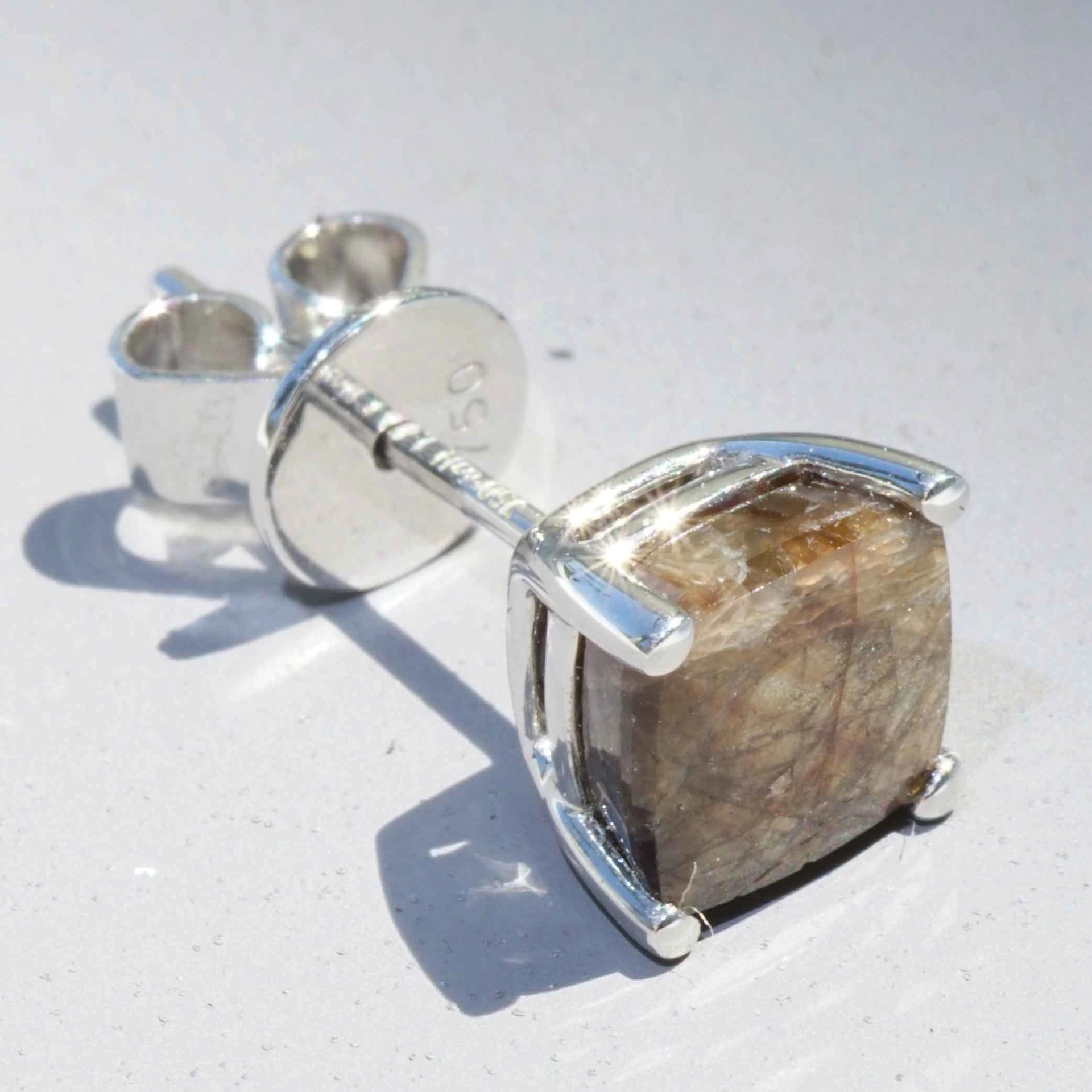Single ear stud with a rare gold colored sapphire