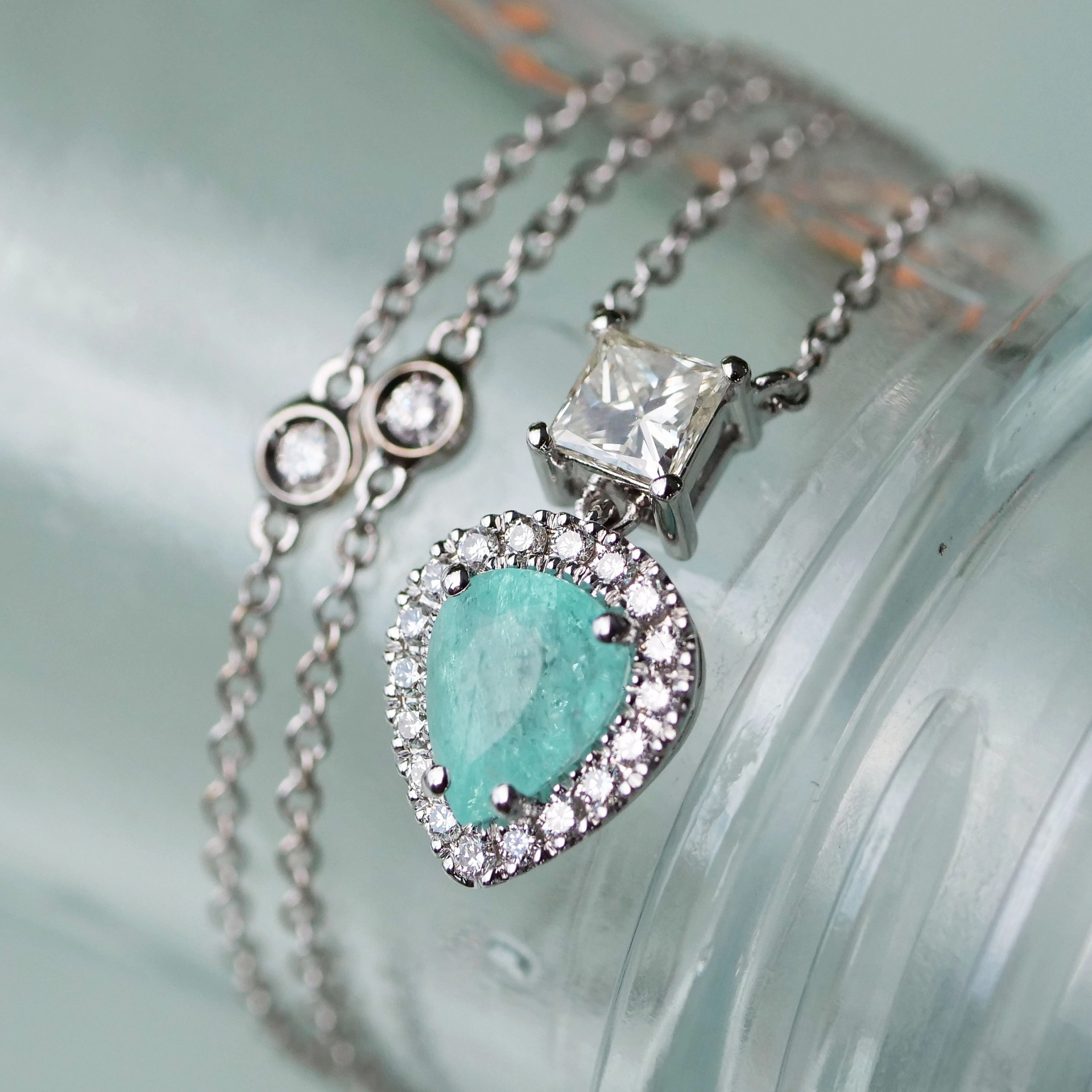 great paraiba turmalin of 1.18 ct, AAA brilliant. swimmingpool blue-green color, original from brasil, 18 kt whitegold, combinated with a princess cut diamond 0.36 ct